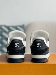 Embrace iconic style with a contemporary twist in these Louis Vuitton Trainer-inspired sneakers. The classic low-top silhouette is reimagined with a stylish black and white denim upper, adorned with the signature Louis Vuitton monogram pattern. The clean lines and chunky sole create a versatile look that's perfect for everyday wear, while the subtle branding adds a touch of understated luxury. Your order arrives in a branded shoe box, complete with dust bags, extra laces, socks, a care booklet, Designer Black High-top Sneakers With Logo Print, Luxury Black High-top Sneakers With Logo, Luxury Black Sneakers With Logo Print, Black Custom Sneakers With Logo Detail, Luxury Black Sneakers With Logo, Casual Black Custom Sneakers With Logo, Casual Black Custom Sneakers With Logo Detail, Trendy Black Sneakers With Logo, Trendy Black Sneakers With Logo Print