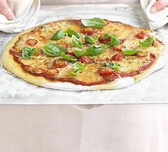 a pizza sitting on top of a pan covered in toppings