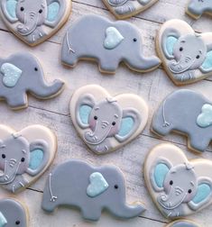 cookies decorated with blue and gray icing are arranged in the shape of an elephant