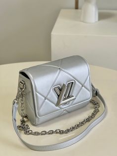 Inspired by winter ice, this scintillating Twist PM handbag is fashioned from sheepskin leather in a radiant silver that’s truly eye-catching. The shimmering effect is enhanced by the silver-color LV Twist lock, rivets and chain. It can be on the shoulder or cross-body thanks to its detachable and adjustable leather strap. Detailed Features 19 x 15 x 9 cm (Length x height x width ) Argent Sheepskin leather Calfskin-leather trim Microfiber lining Silver-color hardware LV Twist lock Inside flat po Scholarships 2023, Lv Twist, Lv Bag, Louis Vuitton Twist Bag, Saudi Arabia, Rivets, Leather Trims, Inside Pocket, Silver Color