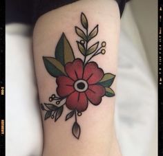 a woman's arm with a flower tattoo on the left side of her arm