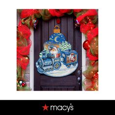 a christmas door decoration with santa riding a train