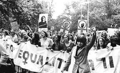 a group of people holding up signs in the middle of a street with words above them