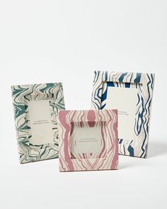 three different colored paper bags sitting next to each other