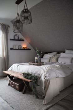 a bed with white sheets and pillows in a room