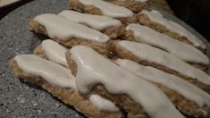 some kind of food that is sitting on a stone plate with icing on it