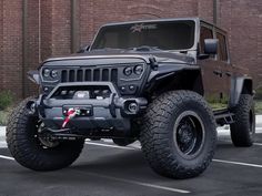 a black jeep parked in front of a brick building