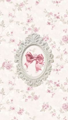 a wallpaper with pink flowers and a bow in the frame on it's side