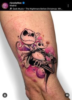 a person with a tattoo on their leg that has a skeleton holding a baby in it's arms