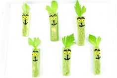 green vegetables with faces drawn on them are arranged in the shape of people's heads