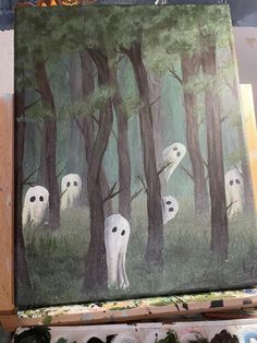 a painting with white ghost faces in the woods