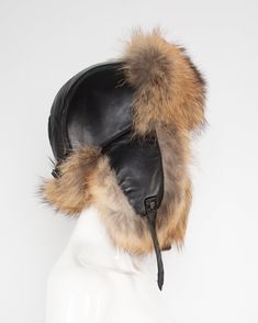 Embrace the season’s charm with this statement-making fur-trimmed trapper hat, a perfect blend of rustic appeal and sophisticated warmth. Crafted from supple buffed lambskin leather, this luxurious piece is encircled with fine, real fur that adds a touch of opulence to every edge. But beyond its high-fashion finish, this cap is built to withstand winter’s harshest elements. Whether you’re navigating city streets or conquering the slopes, the fur-lined earflaps ensure you stay comfortably insulat Luxury Winter Hats With Faux Fur Lining, Luxury Winter Hat With Faux Fur Lining, Trapper Hat, Trapper Hats, Big City, Polyester Satin, Real Fur, City Streets, Lambskin Leather