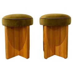 two stools made out of wood and green velvet