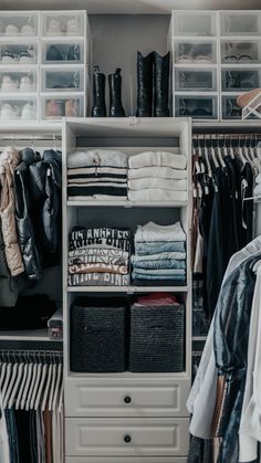 an organized closet with clothes and shoes