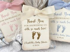 three baby feet tags with the words thank you for showering us