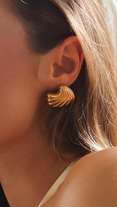 Elevate your style with these stunning Gold Seashell Earrings. Featuring a chic seashell shape and a luxurious gold finish, these earrings add a touch of elegance to any outfit. Perfect for any occasion, they secure comfortably with a gold clasp back. Shell-shaped Metal Earrings, Metal Shell-shaped Earrings, Gold-plated Shell-shaped Earrings, Gold Plated Shell-shaped Earrings, Elegant Shell-shaped Earrings, Elegant Shell-shaped Metal Earrings, Gold Shell Earrings For Summer, Gold Shell-shaped Metal Earrings, Elegant Shell-shaped Gold Plated Earrings