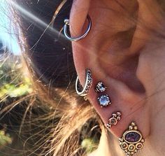 the ear is adorned with different types of jewels