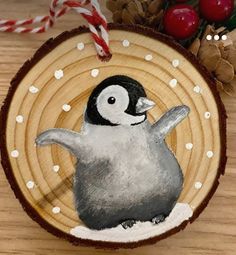 an ornament with a penguin painted on it