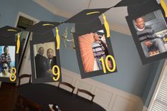 graduation decorations hanging from the ceiling with photos on them and yellow streamers in front of them