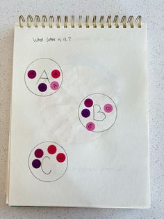 a spiral notebook with three circles drawn on it