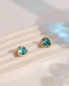 Step into the world of elegance with our Austrian Crystal Stud Earrings in a vibrant blue color, resembling aquamarine gemstones! These stunning earrings feature amorphous Austrian crystals delicately adorned with gold frames, infusing every ensemble with timeless sophistication. Crafted with care, they boast 925 sterling silver earring posts and opulent 18k matte gold plating, promising durability and lasting charm while weighing just 0.08 oz. Each pair is meticulously crafted with a unique ham Modern Blue Earrings With Gemstone Accents, Blue Birthstone Earrings For Formal Occasions, Elegant Aquamarine Jewelry For May Birthstone, Formal Blue Birthstone Earrings, Blue May Birthstone Jewelry For Formal Occasions, Modern Blue Aquamarine Jewelry, Light Blue Gemstone Earrings - Fine Jewelry, Blue Aquamarine Earrings Fine Jewelry, Fine Jewelry Blue Aquamarine Earrings