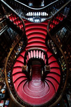 a spiral staircase in a library filled with books