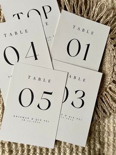 four black and white wedding table numbers