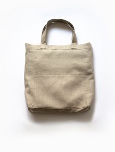 The Mitaka Linen Large Bag is the perfect bag to carry day to day. Made of 100% linen, this lightweight bag won’t add any extra burden on your shoulder. With its double layers of fabric, this bag has the ideal sizing and durability for your tablet, wallet, and office materials. The three pockets are great for organizing your supplies. An added bonus is that The Mitaka Linen Bag is reversible, so your inside pockets can be transformed into outside pockets with a quick tug and a flip! Reversibility for style and function. Made of double layers of 100% linen. Double sided clean-finish seams. 3 pockets. 16”H x 14-3/4”W x 3-1/4”D. 8-1/2” shoulder drop. Made in the USA. Care Instructions: Machine wash. Ironing as needed. Versatile Daily Use Shoulder Bag With Flat Pocket, Versatile Shoulder Bag With Flat Pocket For Daily Use, Everyday Neutral Cotton Bags, Eco-friendly Linen Canvas Bag For Daily Use, Eco-friendly Neutral Bag For Daily Use, Casual Linen Canvas Bag For Everyday, Neutral Rectangular Canvas Bag For Daily Use, Casual Everyday Linen Canvas Bag, Rectangular Neutral Canvas Bag For Daily Use