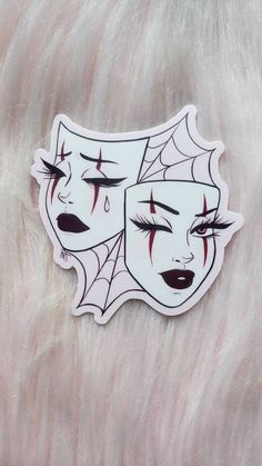 a white sticker with red eyes and spider webs on it's face