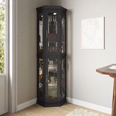 a tall black corner cabinet with glass doors