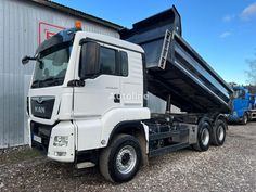 a dump truck parked in front of a building