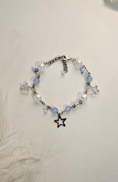 Silver Beaded Pastel Bracelet with Silver Star Charm, Fairy Core and y2k Made with Glass and Czech Beads, Stainless Steel Chain 7 inches with 1 inch adjuster  CARE: - Keep out of water when in for long periods of time - Store in dry area Star Aesthetic Y2k Jewelry, Blue Aesthetic Accessories, Blue And Silver Aesthetic, Blue Beaded Jewelry, Y2k Bracelets, Beads Aesthetic, Bracelets Aesthetic, Bracelet Y2k, Fairy Bracelets