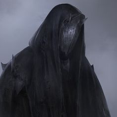 a black hooded figure standing in the fog