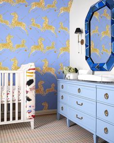 a baby's room decorated in blue and gold