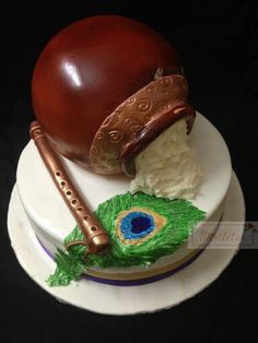 there is a cake that looks like an instrument on top of the cake, and it's made to look like a peacock