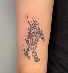 a tattoo on the arm of a person with a dog design in black and white