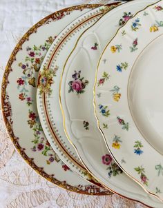 a stack of fancy plates sitting on top of a table