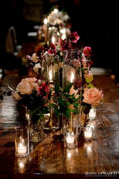 candles and flowers are arranged on the table