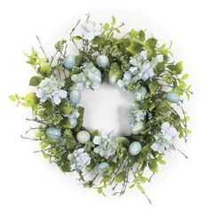 a wreath with blue flowers and green leaves