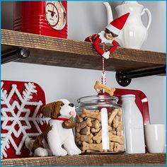 an elf is sitting on top of the shelves with his dog and cat food in front of him