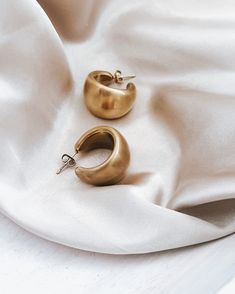 Our Enoch Matte Gold Earrings are the perfect touch of luxe to transform any look. Exquisitely crafted in a matte gold tone, these statement earrings add a sophisticated and unique element to any ensemble. Crafted with waterproof material, these earrings are perfect for any occasion - rain or shine! Brushed, Matte Gold finish 2 sizes to choose from Waterproof Tarnish resistant 18K Gold plated stainless steel Hypoallergenic Matte Gold Plated Minimalist Earrings, Gold Matte Finish Jewelry Gift, Matte Finish Gold Jewelry Gift, Chic Gold-tone Brass Earrings, Chic Gold Brass Earrings, Modern Gold Jewelry With Matte Finish, Minimalist Gold Jewelry With Matte Finish, Matte Gold Minimalist Metal Earrings, Matte Gold Minimalist Earrings