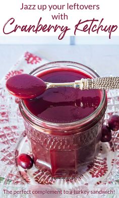 a jar filled with cranberry ketchup sitting on top of a table