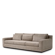 a beige couch sitting on top of a white floor