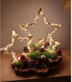 a wooden table topped with a cake covered in lights