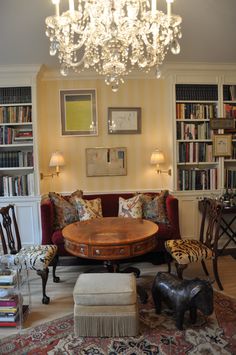 a living room filled with furniture and a chandelier