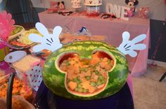 a watermelon shaped like mickey mouse with food in the shape of ears on it