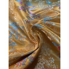 an image of a gold and blue flowered fabric with metallic foil on the bottom