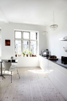 the kitchen is clean and ready to be used for cooking or dining, while also being used as an office