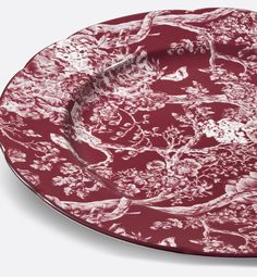 a red and white plate with trees on it