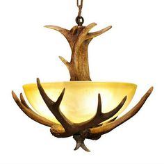 a light fixture with antlers hanging from it's center and two lights on each side